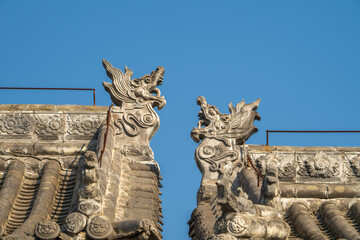 Fototapeta premium Roof carvings on traditional Chinese houses.