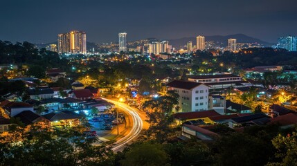 Fototapeta premium Night cityscape panorama showing city lights, buildings, roads, and trees.