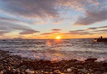 Cinematic Serene Coastal Sunrise with Waves and Pebble Beach in Ikaria, Greece