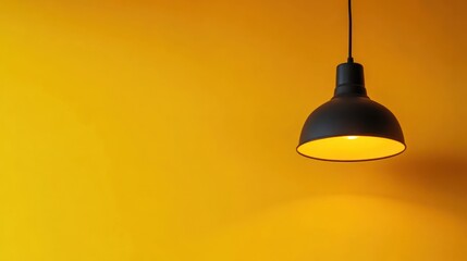 Obraz premium Illuminating Minimalism: A Black Pendant Lamp Against a Vibrant Yellow Wall
