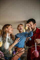 The family decorates eggs and enjoys quality time together. Easter preparations concept