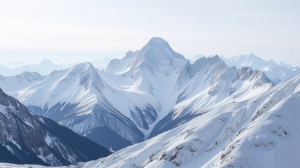 Fototapeta premium Snowy mountain range under clear blue sky
