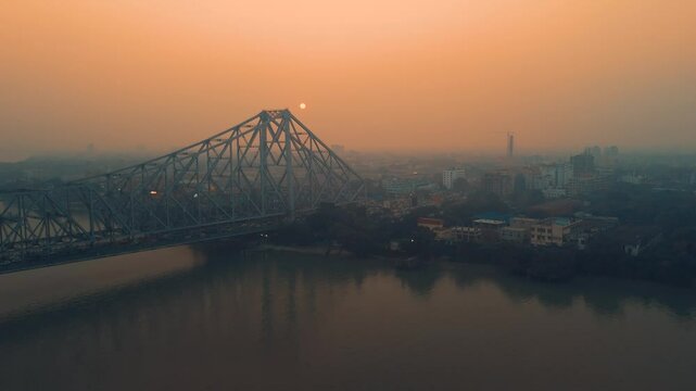 Aerial view of Kolkata Iconic Howrah Bridge or Rabindra Setu over Ganga River during Sunset
