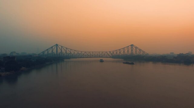 Aerial view of Kolkata Iconic Howrah Bridge or Rabindra Setu over Ganga River during Sunset