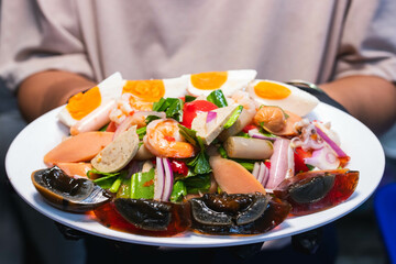 Papaya salad with preserved egg, salted egg, sausage, pork roll, salmon,  thai food, recommended thai food