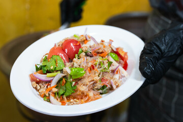 Spicy Glass Noodle Salad,mixed shrimp with minced pork and squid (Yum Woon Sen) in white plate.