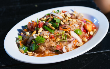 Spicy Glass Noodle Salad,mixed shrimp with minced pork and squid (Yum Woon Sen) in white plate.