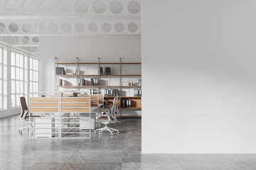 Modern open space office interior with shelves, desks, and chairs in a spacious loft-style room with large windows and gray flooring. 3D Rendering