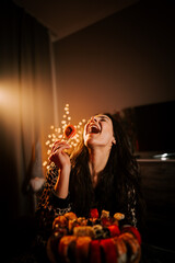 Enjoying sushi in bed while wearing pajamas in cozy warm light