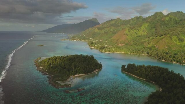 Aerial drone footage stunning beauty of Moorea tropical island in French Polynesia, green mountains, turquoise lagoon coral reef. Popular travel destination, remote wild paradise, exotic summer travel