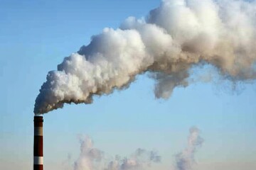 Emissions from Industrial Chimney Releasing Thick Smoke into Clear Blue Sky Representing Environmental Pollution and Industry Challenges