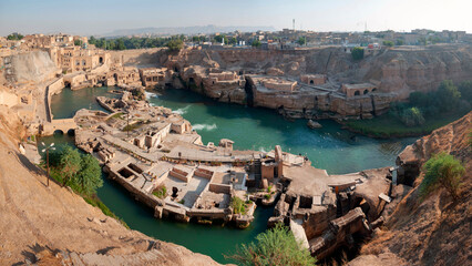 Shushtar is an ancient fortress city. Much of its past agricultural productivity derives from the Roman-built irrigation system which centered on the Band-e Kaisar, the first dam bridge in Iran.