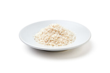 Psyllium husk powder on white plate isolated on white background. Psyllium husk has increasing the volume of feces and amount of water in the intestines, It's used as a laxative to treat constipation.