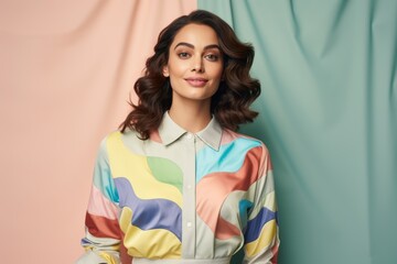 A woman is wearing a colorful shirt with a pattern of waves