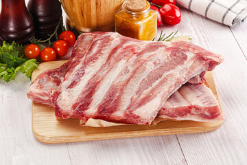 Raw pork ribs over board