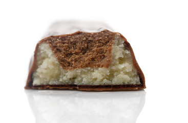 Decadent chocolate bar revealing soft, creamy filling with almond flavor in elegant setting