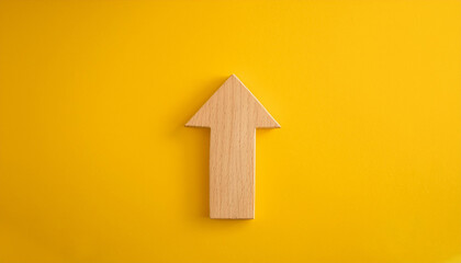 Minimalist wooden arrow on yellow background. Wood pointer, forward direction, up.