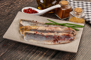 Salted marinated herring fillet with spices