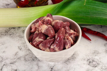 Raw chicken hearts in the bowl