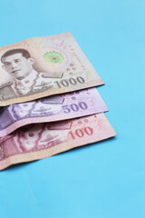 Thai banknotes on blue background.