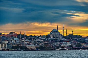 Naklejka premium view from a pleasure boat on the Bosphorus and the cityscape of Istanbul, Turkey, the architecture of the city at sunset, a popular tourist destination.