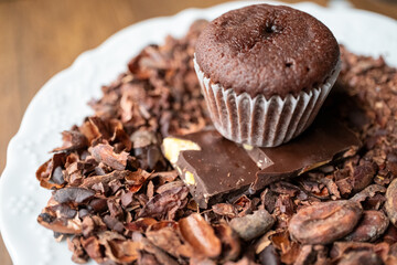 chocolate muffin and cacao beans on a plate