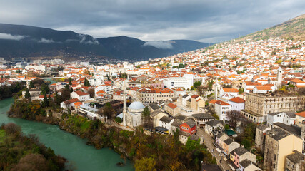 Fototapeta premium Aerial view of people crossing Old Bridge over Neretva river in Mostar, Bosnia and Herzegovina.