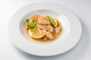 Steamed chicken with vegetables and lemon , traditional Chinese dish isolated on white background