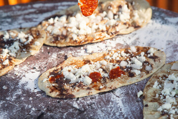 Memela or mamelita is a mexican oval tortilla, handmade with corn dough. They are thick and covered with bean paste and other ingredients.