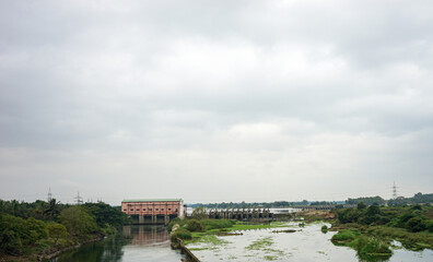 India, Karnataka, a train crossing a bridge over a body of water