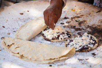 Memela or mamelita is a mexican oval tortilla, handmade with corn dough. They are thick and covered...