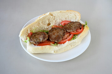 Meatball between bread (Turkish name : ekmek arasi kofte ) Izgara kofte. Manisa, Akcaabat, Akhisar  kofte. Delicious meat grilled meatballs.
