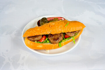 Meatball between bread (Turkish name : ekmek arasi kofte ) Izgara kofte. Manisa, Akcaabat, Akhisar  kofte. Delicious meat grilled meatballs.