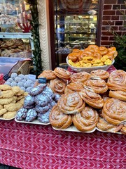 Table filled with cake outside a bakery