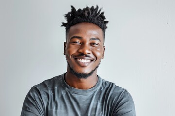Obraz premium Image of handsome smiling young african man standing isolated over white background. Looking camera.