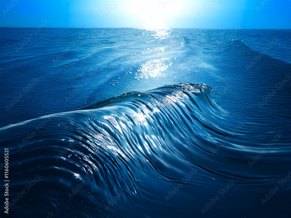 Poster a mesmerizing ocean wave, backlit by the sun, displays its translucent form and glistening surface. 