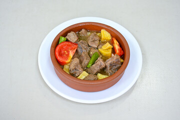 Turkish  Traditional Ramadan doner kebab with tasty tomato sauce and rice or turkish pilav in white plate on table background. Lavash doner kebab ( doner zurna durum )  Pilavustu Doner Iskender kebap