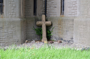 Abandoned Stone Cross in Garden of Old Unused Church