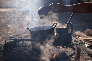 Clay and iron pots at a street food stand in Oaxaca cooking traditional Mexican cafe de olla.