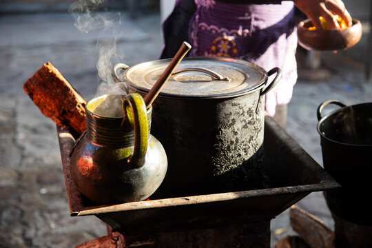 Clay and iron pots at a street food stand in Oaxaca cooking traditional Mexican cafe de olla.