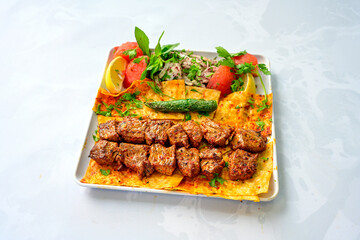 Famous Urfa meat liver, ciger wrapped by lavash with roasted chili pepper, onion and sauce in Sanliurfa, Turkey. Kuzu et ciger sis. Izgara dana bonfile, cop sis, kuzu pirzola. Karisik kebap, beyti keb