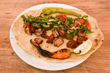 Famous Urfa meat liver, ciger wrapped by lavash with roasted chili pepper, onion and sauce in Sanliurfa, Turkey. Kuzu et ciger sis. Izgara dana bonfile, cop sis, kuzu pirzola. Karisik kebap, beyti keb