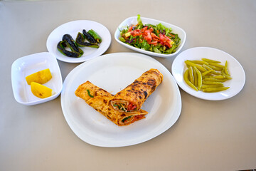 Lavash doner kebab ( soslu kasarli zurna doner durum )  or shawarma sliced in plate isolated.  Tavuk Et Doner Durum. Hatay Iskenderun usulu bazuka, zurna  tavuk doner durum. 