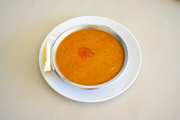 Turkish Ezo Gelin soup, Traditional Turkish Soup. Geleneksel Ezogelin corbasi. Ezogelin Soup Served with a slice of lemon. Top view