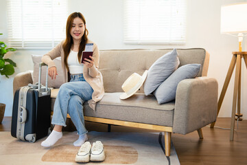 Obraz premium Travel preparation. Cheerful young asian woman packing suitcase, getting ready for vacation at home, copy space. Female going on tourist trip, happy about abroad adventure.