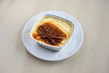 Baked rice pudding turkish milky dessert sutlac, keskul  (Turkish name; firin sutlac). Findikli Hamsikoy Sutlac