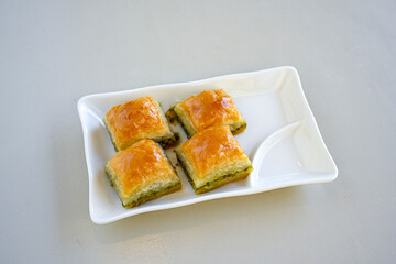 Turkish Dessert Sobiyet, havuc dilimi, midye baklava, mussels baklava and classic baklava with Pistachio . Cikolatali cevizli, fistikli soguk Baklava, top view.