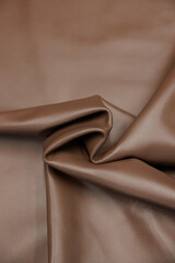 Leather texture: Elegant folds and shading A representation of high quality leather with visible wrinkles and shading that highlight the softness and structure of the material.