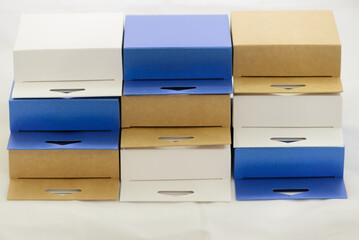 brown white and blue cardboard gift boxes on white background