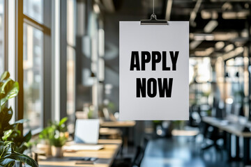Apply now message written on white paper in office